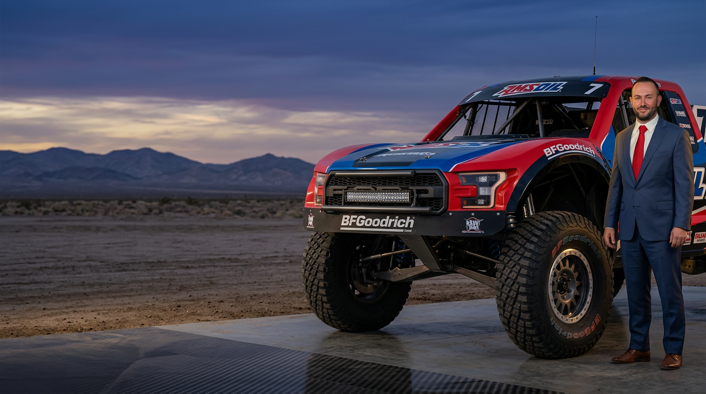 Eric Riley, Independent AMSOIL Dealer, beside an AMSOIL-sponsored race truck
